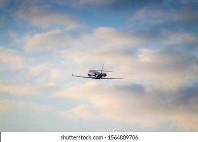 Business Jet Is Taking Off On Sunset With Rising Clouds