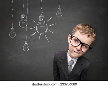  Business Kid Having An Idea. Electric Bulbs Hanging Above His Head