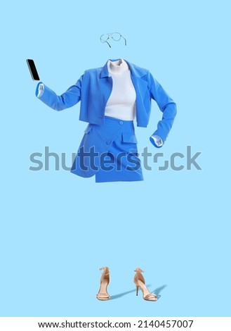 Business lady. Creative portrait of invisible woman wearing modern business style blue outfit and eyeglasses using phone on blue background. Concept of fashion, creativity, art and ad.