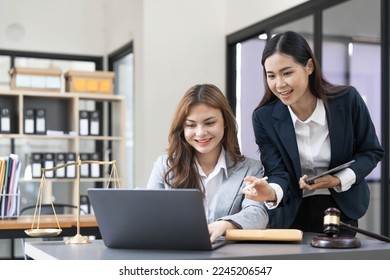 Business law concept, Lawyer business lawyers are consulting lawyers for women entrepreneurs to file copyright lawsuit with laptop and tablet