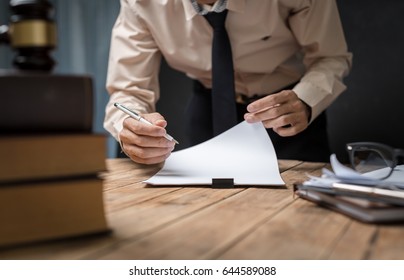 Business Lawyer Working Hard At Office Desk Workplace With Book And Documents.