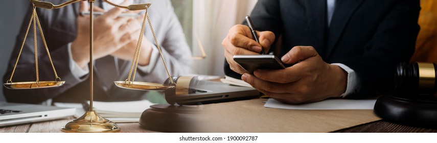 Business and lawyers discussing contract papers with brass scale on desk in office. Law, legal services, advice, justice and law concept - Shutterstock ID 1900092787