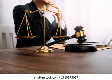 Business and lawyers discussing contract papers with brass scale on desk in office. Law, legal services, advice, justice and law concept  picture with film grain effect - Shutterstock ID 1919573057