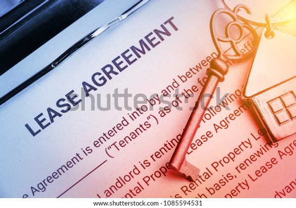Business lease agreement concept : Pen and\
keychain on a lease agreement form. Lease agreement is a contract\
between a lessor and a lessee that allow lessee rights to use of a\
property owned by\
lessor