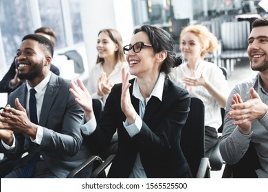 Business lecture. Happy executives applauding to speaker, listening his speech in boardroom - Powered by Shutterstock