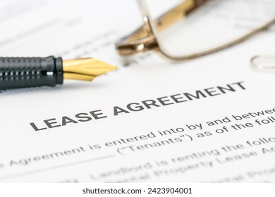 Business legal document concept : Pen and glasses on a lease agreement form. Lease agreement is a contract between a lessor and a lessee that allow lessee rights to use of a property owned by lessor.