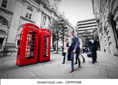 Business Life Concept In London, The UK. Red Phone Booth, People In Suits Walking