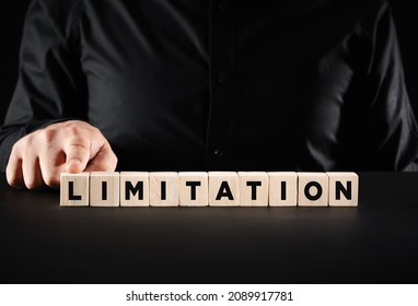 Business limitation or boundaries concep. Businessman presses the wooden cubes with the word limitation. - Shutterstock ID 2089917781