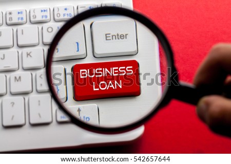 Business Loan word written on keyboard view with magnifier glass