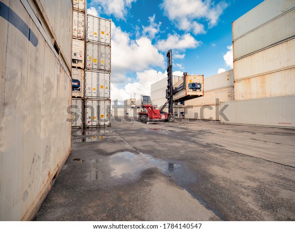 Business\
Logistics concept, Forklift truck handling cargo shipping white\
container box in logistic shipping\
yard.