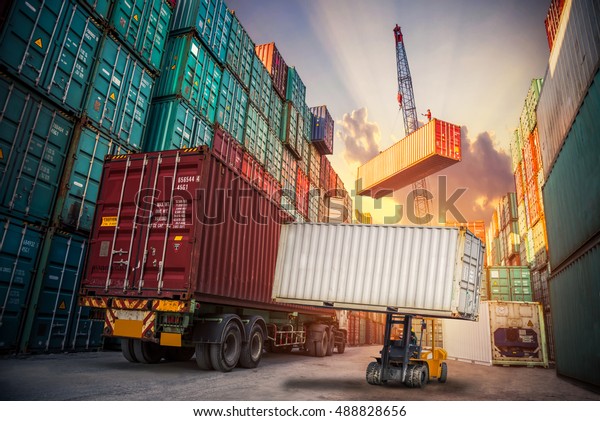 Business Logistics\
concept, Industrial crane loading container to truck for Logistic\
Import Export\
background