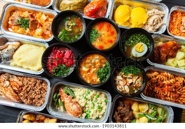 Business lunch in eco plastic container ready\
for delivery.Top view. Office Lunch boxes with food ready to go.\
Food takes away. Catering,\
brakfast