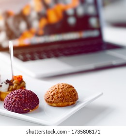 Business Lunch In Office,food Snacks Coockies On White Wooden Desk Near Laptop Computer. Snack At Break Time