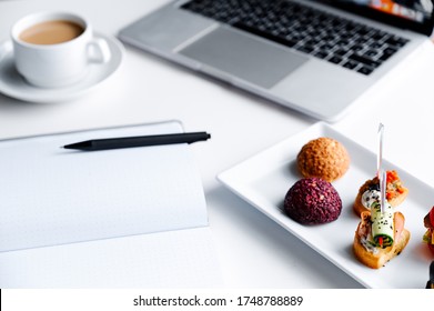 Business Lunch In Office,food Snacks Coockies On White Wooden Desk Near Laptop Computer. Snack At Break Time