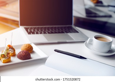 Business Lunch In Office,food Snacks Coockies On White Wooden Desk Near Laptop Computer. Snack At Break Time