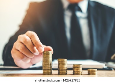 Business man Accounting Calculating Cost Economic budget putting Row and coin Write Finance ,investment and saving concept
