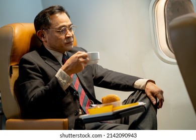 Business Man Act As Happy After Drink Coffee Or Tea With Dessert On Airplane During Go To Work With Big Project In Other Country.