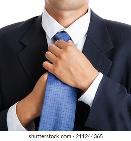 Business man adjusting his necktie