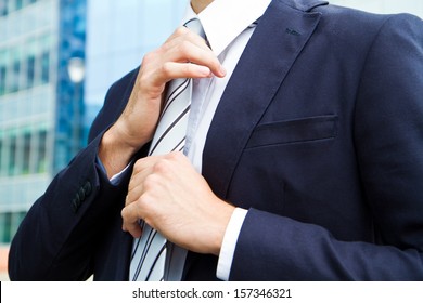 Business Man Adjusting Tie 