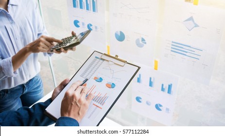 Business man analysis data document with blurred accountant calculating - Powered by Shutterstock