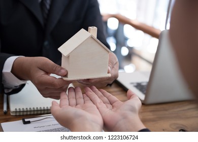 Business Man Applying For Mortgage Loan With Bank Employee. Client Signing Contract Document With Realtor At Real Estate Agency. Property, Finance & Banking Concept