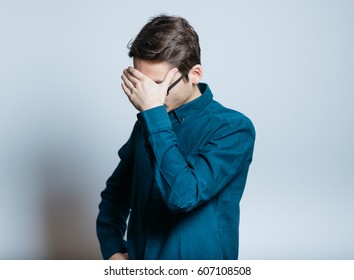Business man is ashamed, isolated on a gray background