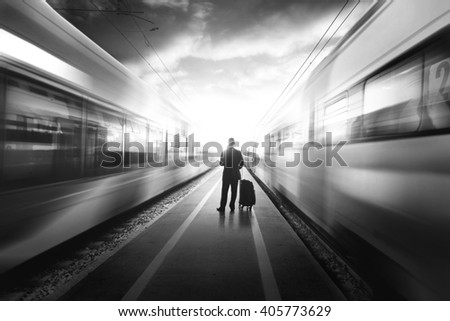 Business man between two fast trains, black and white