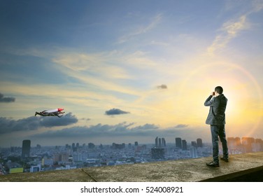 Business Man Binocular To Man With Rocket On Back Flying Over City Scape Comedy Concept In Business Competition Theme