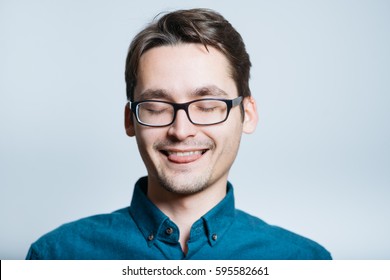 Business Man Biting His Tongue, Isolated On Gray Background