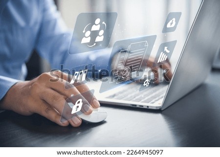 Business man in blue shirt using laptop access files document on virtual screen, document management system concept.