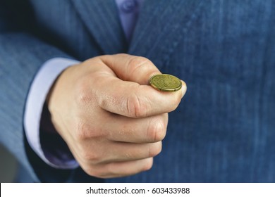 Business Man In Blue Suit Holds Golden Euro Cent On Hand Fingers, Tossing Coin, Heads Or Tails Game