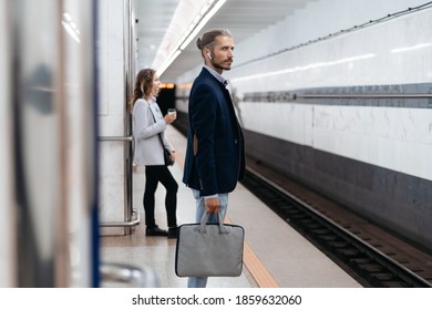 Business Man With A Briefcase Waiting For A Train At Subway Station