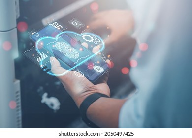 Business man builds a virtual interface using smartphones to exchange data storage for industrial networking, cloud technology concept.
