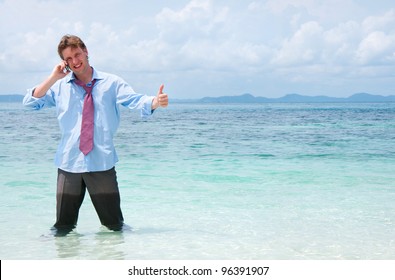 Business Man Calling By Cell Phone On The Beach