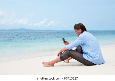 Business Man Calling By Cell Phone On The Beach