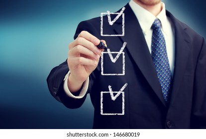 Business Man With Check Boxes Over Navy Blue Background