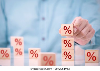 Business man chooses a wood cube block on top with percent symbol icon , concept of financial , Interest rate and mortgage rates