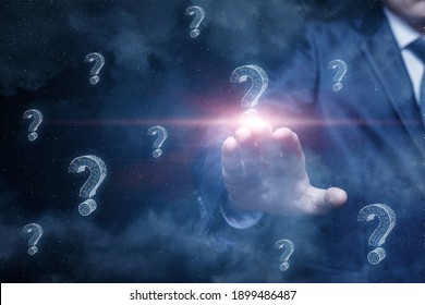 Business Man Clicks Question Mark On Outer Space Background.