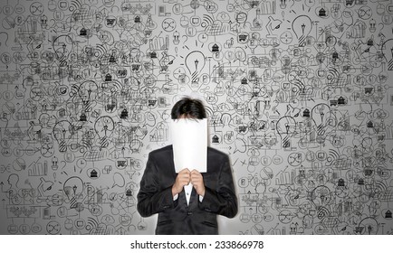  Business man covering his face with blank paper on business and technology background - Powered by Shutterstock