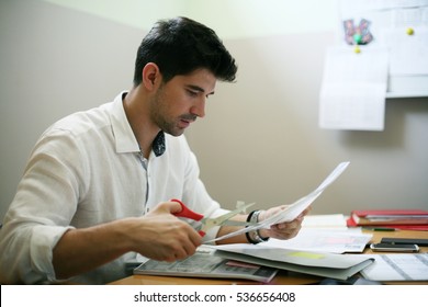 Business Man Cutting Paper In Office. 