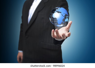 Business Man With The Digital Globe Ball Floating On His Hand. Concept For Connectivity, Communication Within Grasp.