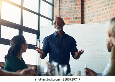 Business man doing presentation, planning and talking in a meeting, seminar or training conference in a boardroom at work. Employees listening to a manager, making plans and working together - Shutterstock ID 2188929749