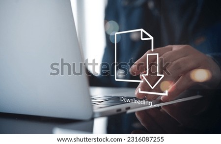 Business man downloading computer files or installing software on laptop computer, cloud storage technology, data backup, cyber security, document downloading