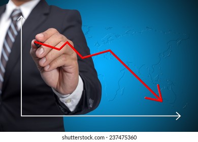 Business Man Drawing Decline Graph Over Blue Background