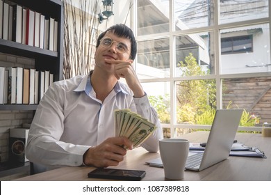 Business man is dreaming of more money working online