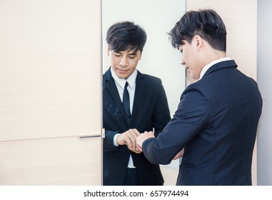 Business Man Dressing Up For Work In Front Of The Mirror