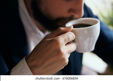 Business man drinking coffee in a cafe                                - Powered by Shutterstock