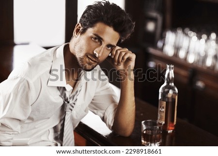 Business man, drinking and portrait in happy hour at a bar with alcohol and whiskey after work. Bottle, male person and face in a restaurant with a playboy guy and a glass and confidence in pub