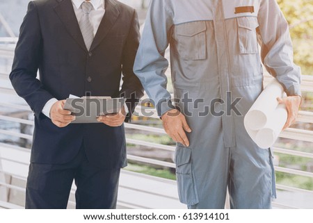 Business man and engineer or foreman standing. Engineering and constrcution concept.