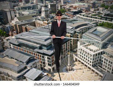 Business man in equilibrium on a rope over a city